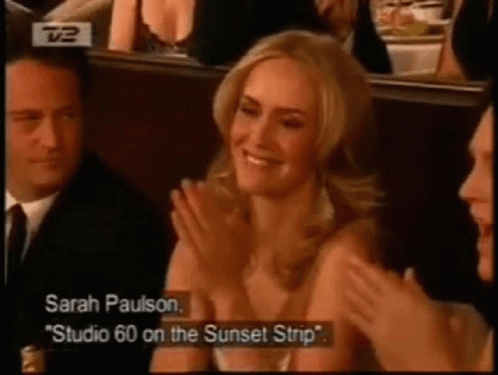 Sarah Paulson Is Applauding While Sitting In A Row Of People GIF