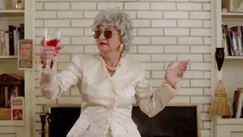 Sassy Old Lady Dancing While Drinking Wine GIF