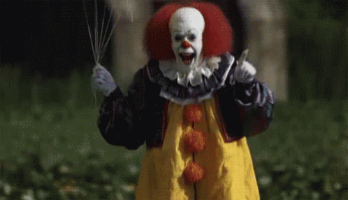 Scary Clown Holding Knife and Balloon