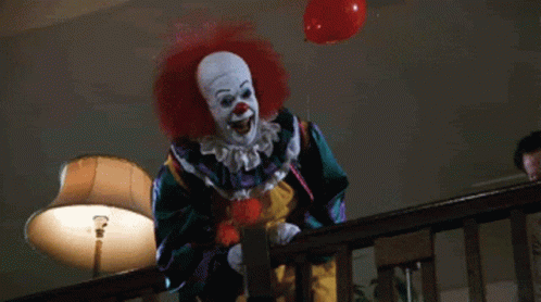Scary Clown Holding Red Balloon
