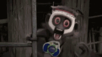 Scary Monkey Holding Toy Gun in Dark Room