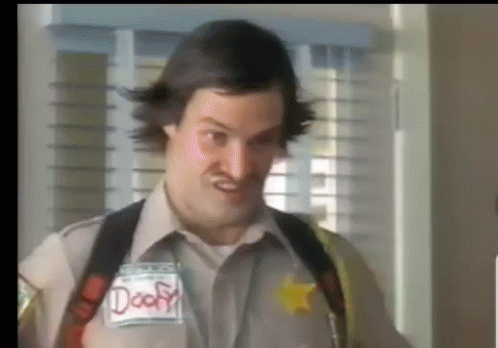 Scary Movie Officer Doofy Pointing At His Badge GIF