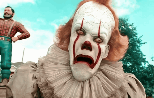 Scary Red-Eyed Clown Before Man in Suspenders