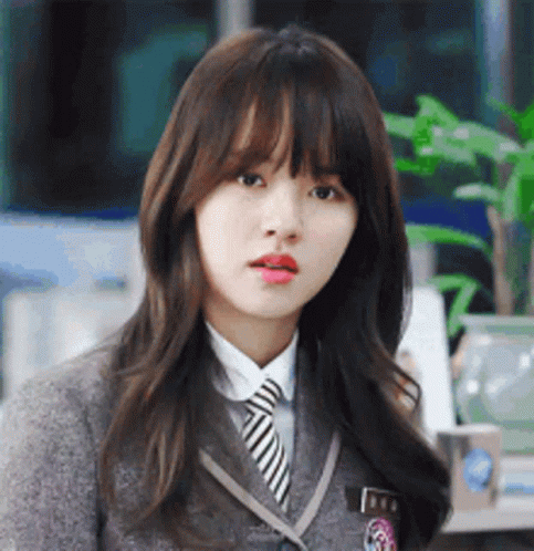Schoolgirl with Striped Tie Looking at Camera