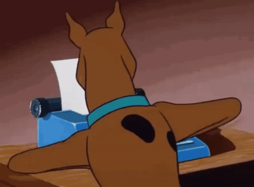 Scooby Doo Is Typing On A Typewriter And Looking At A Piece Of Paper That Says " Help " GIF