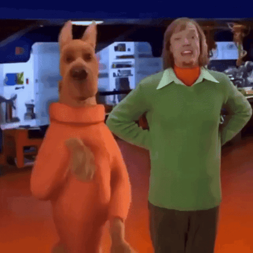 Scooby Doo Next to Man in Green Sweater