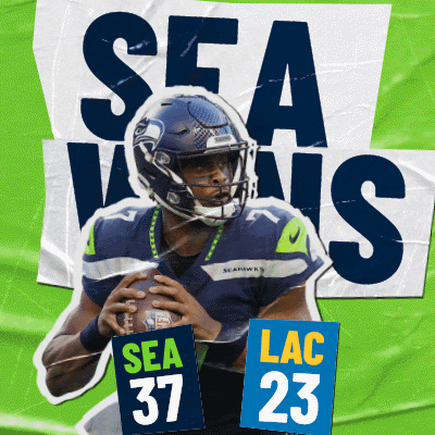 Seahawks Player Holding Football and Sign Saying Sea 37