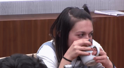 Girl With Obvious Secret Drinking Cup GIF