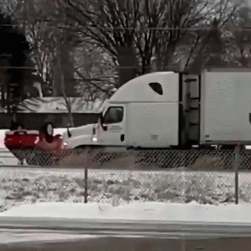 Semi Truck Driving on Snow Covered Highway
