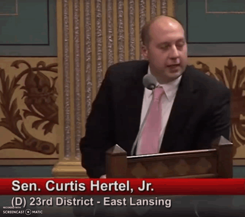 Sen Curtis Hertel Jr. Giving Speech at Podium