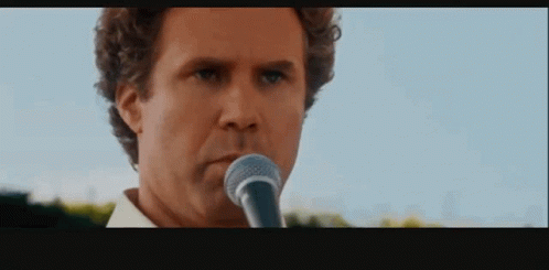 Serious Man Singing Into Microphone GIF