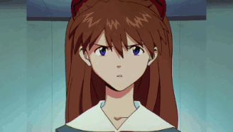 Serious Redhead Girl With Blue Eyes Looking At Camera GIF