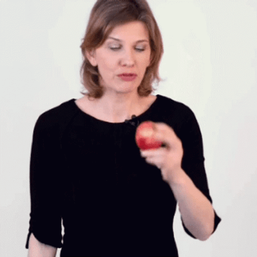 Serious Woman Biting An Apple GIF
