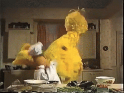 Sesame Street Big Bird Is Dancing In A Kitchen With Plates And Bowls GIF