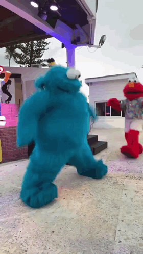 Sesame Street Characters Cookie Monster And Elmo Are Dancing GIF