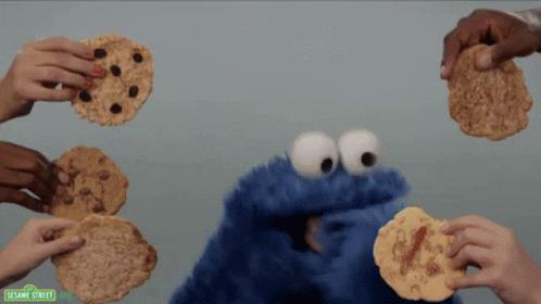 Sesame Street Cookie Monster Being Surrounded By People Holding Cookies GIF