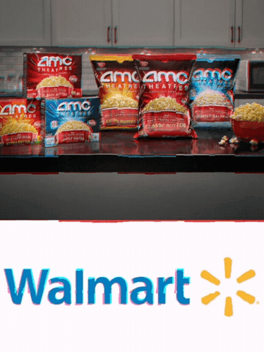Several Bags Of Amc Popcorn Sit On A Counter GIF