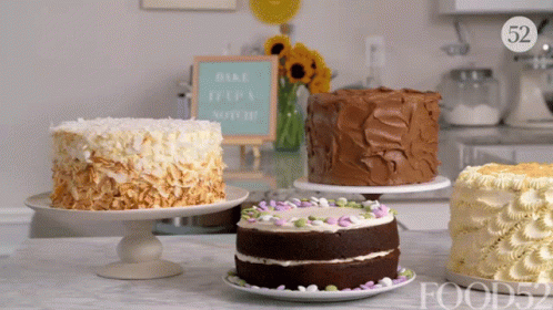Several Cakes On A Table With A Sign That Says Bake It 'S A Special Day GIF