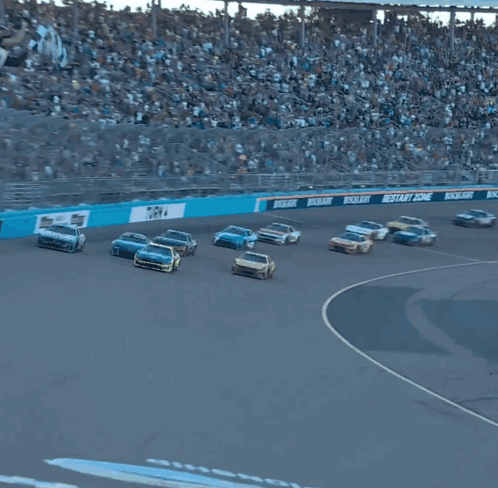 Several Cars Are Racing On A Race Track With A Sign That Says Championship GIF