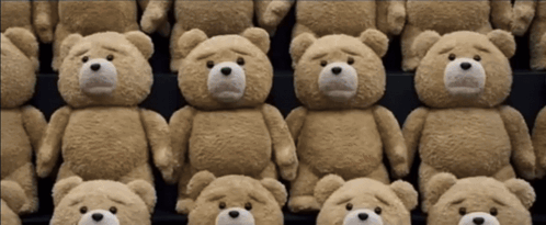 Several Teddy Bears Are Lined Up In A Row With Sad Faces GIF