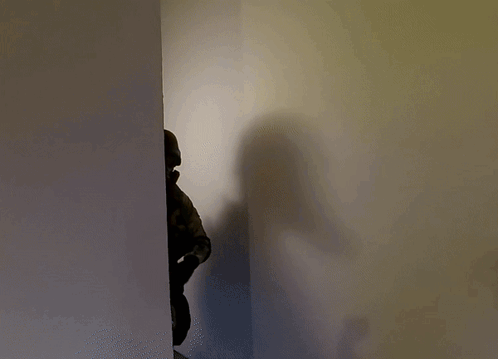 Shadow of Person in Helmet and Gas Mask