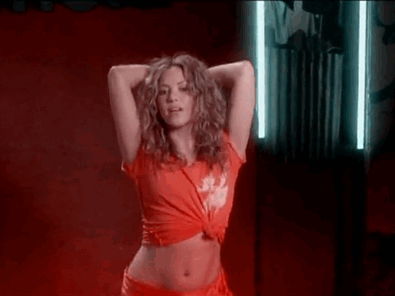 Shakira Is Wearing A Red Crop Top And Red Shorts While Dancing In A Red Room . GIF