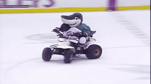 Shark Mascot Riding Four Wheeler on Ice Rink