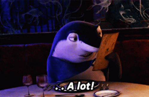 Shark Sitting at Table With A Lot Sign