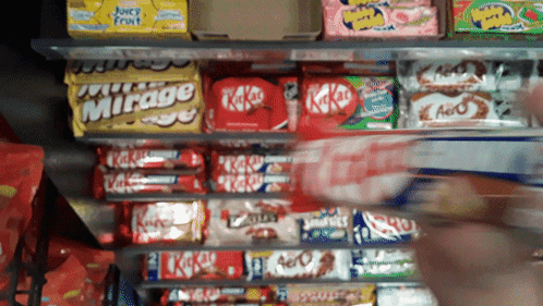 Shelf Full of Candy Including KitKats and Mirage
