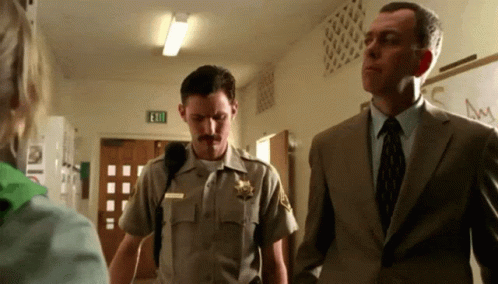 Sheriff in Uniform Next to Suit Man