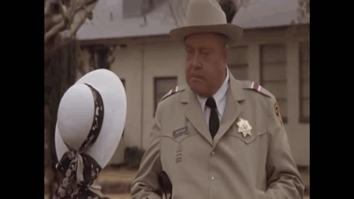 Sheriff Talking To Woman In White Hat GIF