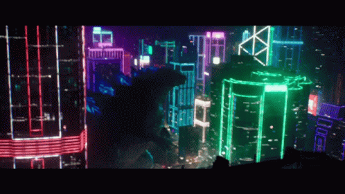 Shin Godzilla Passing Thru Lighted Buildings GIF