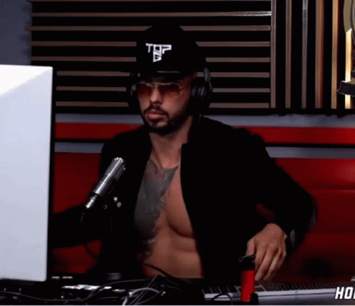 Shirtless Andrew Tate Wearing Cap On Podcast GIF