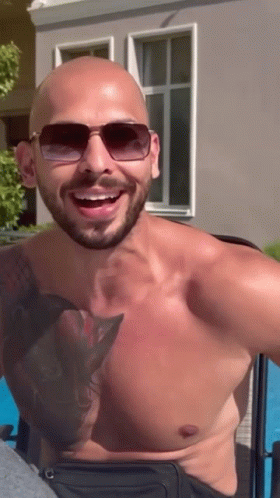 Shirtless Andrew Tate Wearing Sun Glasses Laughing GIF