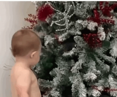 Shirtless Baby Next To Christmas Tree GIF