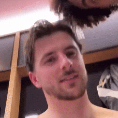 Shirtless Bearded Man Looking at Camera