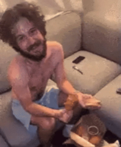 Shirtless Bearded Man Sitting on Couch