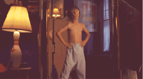Shirtless Boy Dancing In Dark Room With Lamp GIF