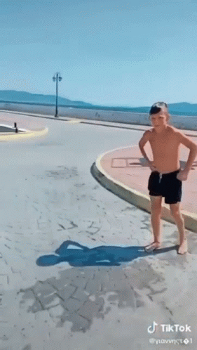 Shirtless Boy Jumping Off Pier Into Water GIF