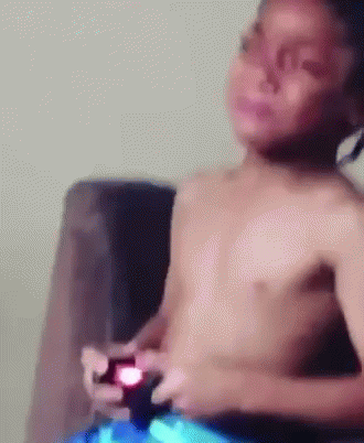 Shirtless Boy Playing Video Game on Couch