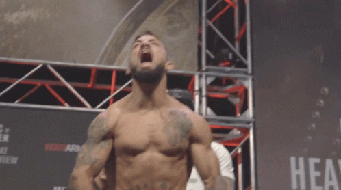 Shirtless Fighter in Front of Hea Sign
