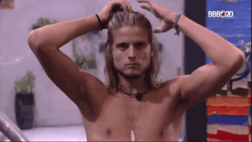 Shirtless Long-Haired Man in Front of BB2020 Screen