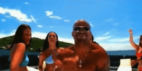 Shirtless Man And Two Bikini Women On Beach GIF
