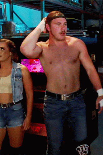 Shirtless Man and Woman in Denim Vest