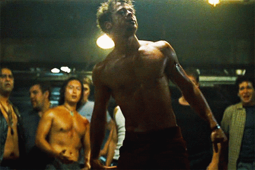 Shirtless Man Before Group of Men