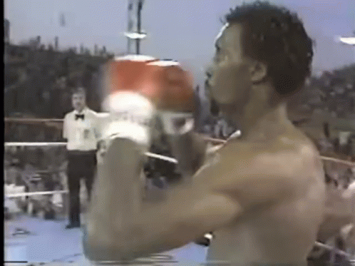 Shirtless Man Boxing Gloves in Ring