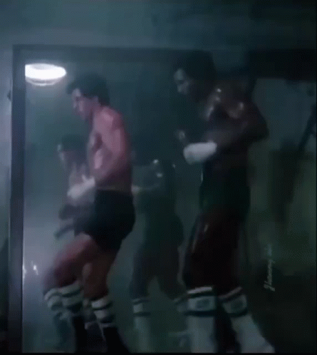 Shirtless Man Boxing in Dark Room