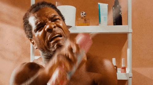 Shirtless Man Brushing Teeth