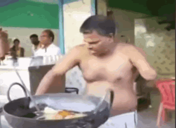 Shirtless Man Cooking in Pot in Restaurant