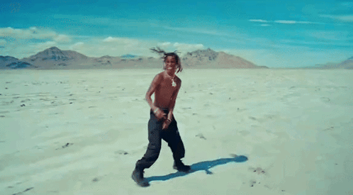 Shirtless Man Dancing In Desert GIF